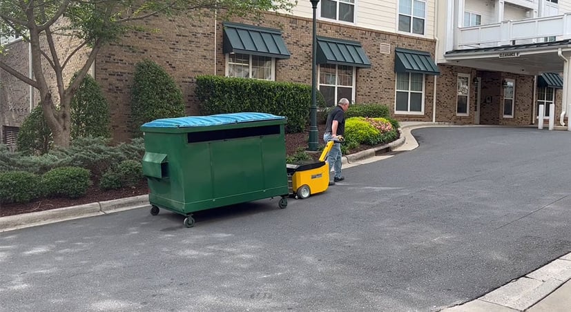 DumpsterMover300 moving a dumpster up a slope