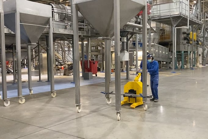 electric tug moving stainless steel hopper in food production