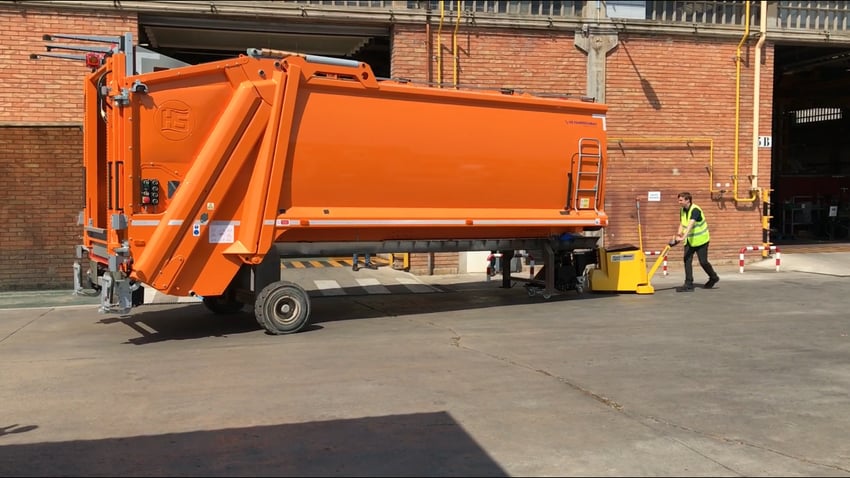 Moving heavy commercial waste lorry with electric tug