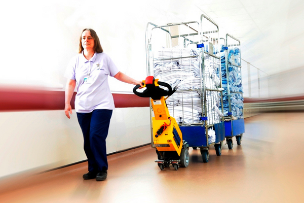 electric tug moving roll cages in hospital 