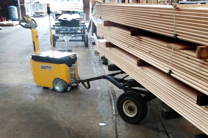 electric tug moving wood at timber yard