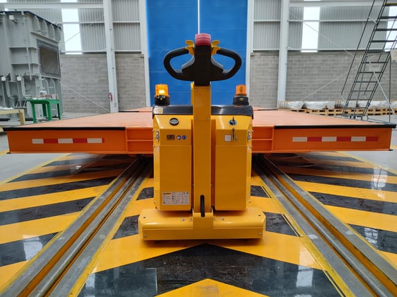 Tugger moving transformer platform on rails