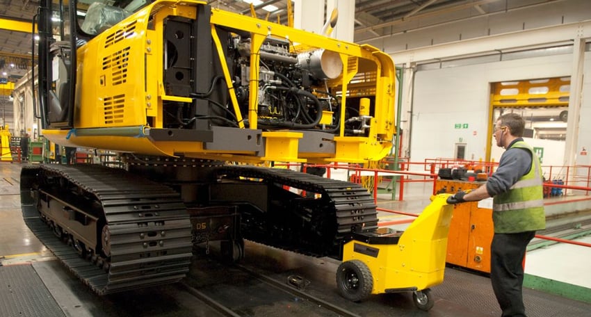 electric tug moving heavy load in heavy plant factory