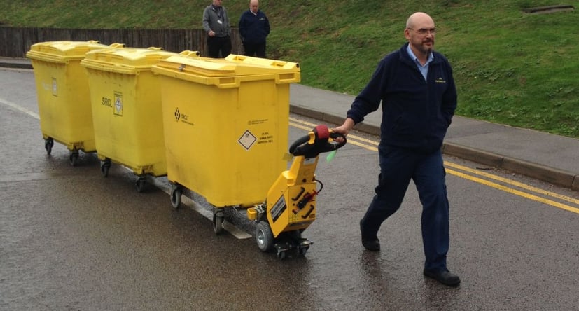 SmartMover SM100+ moving 3 commercial bins along a road