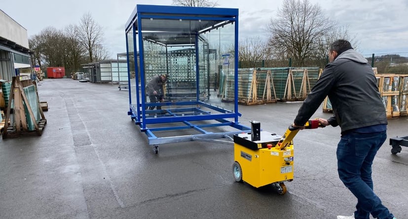 MasterTow zieht eine Bushaltestelle aus Glas auf einem Transportwagen