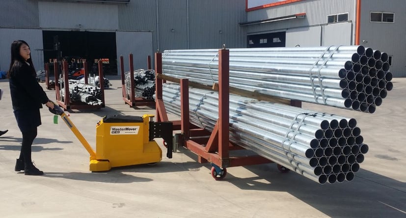 MasterTug MT400+ moving processed metal pipes on a trolley outdoors