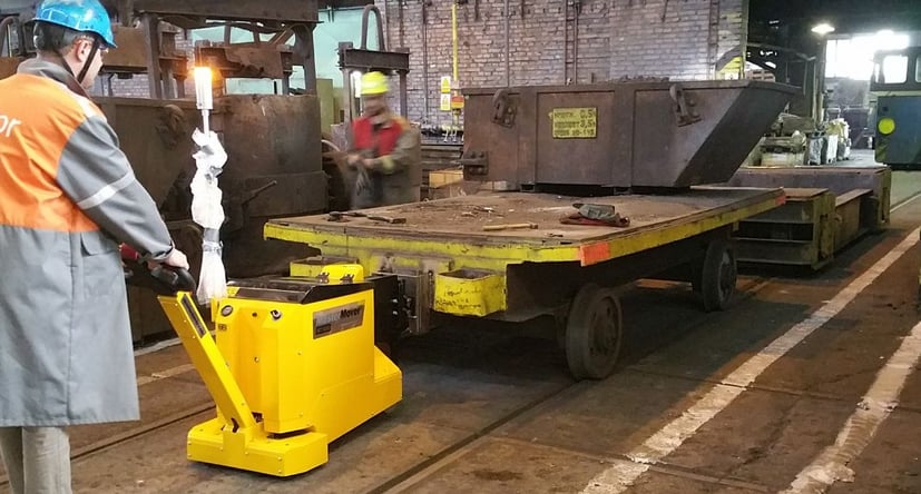 MasterTug MT600+ moving steel on a trailer on rails