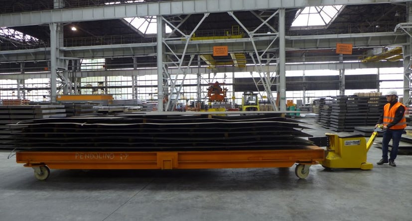 MasterTug moving large steel sheets on trolley