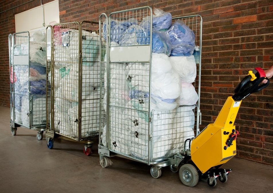 SmartMover SM100+ moving linen cages in a hospital