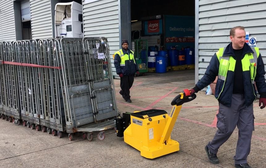 MasterTug moving nested roll cages outside a warehouse